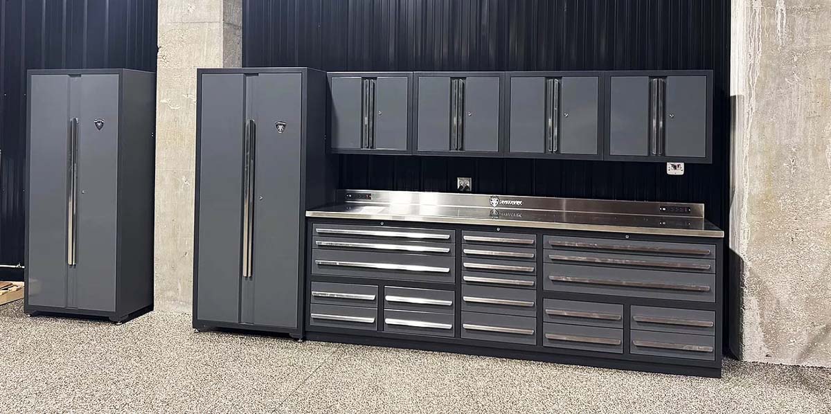 Set of workbench, wall cabinets, and locker cabinets on an epoxy floor against a black steel wall