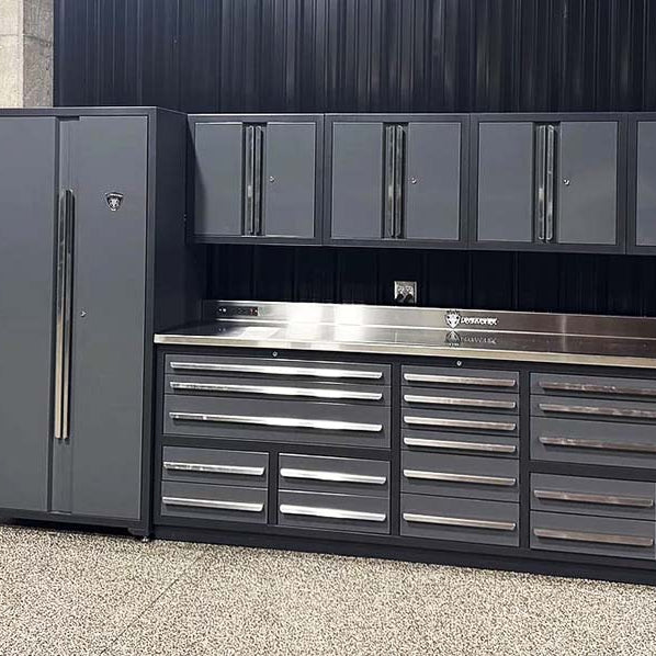Set of workbench, wall cabinets, and locker cabinets on an epoxy floor against a black steel wall